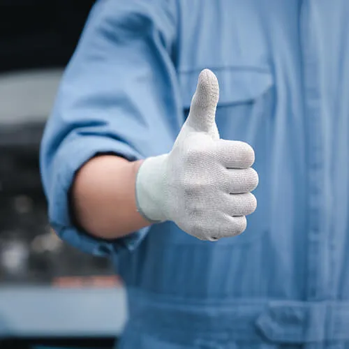 Worker in gloves giving thumbs up gesture